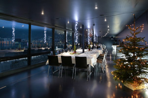 Weihnachtlich dekorierte Tafeln in der Blauen Lounge mit Blick auf den Bodensee in Abendstimmung